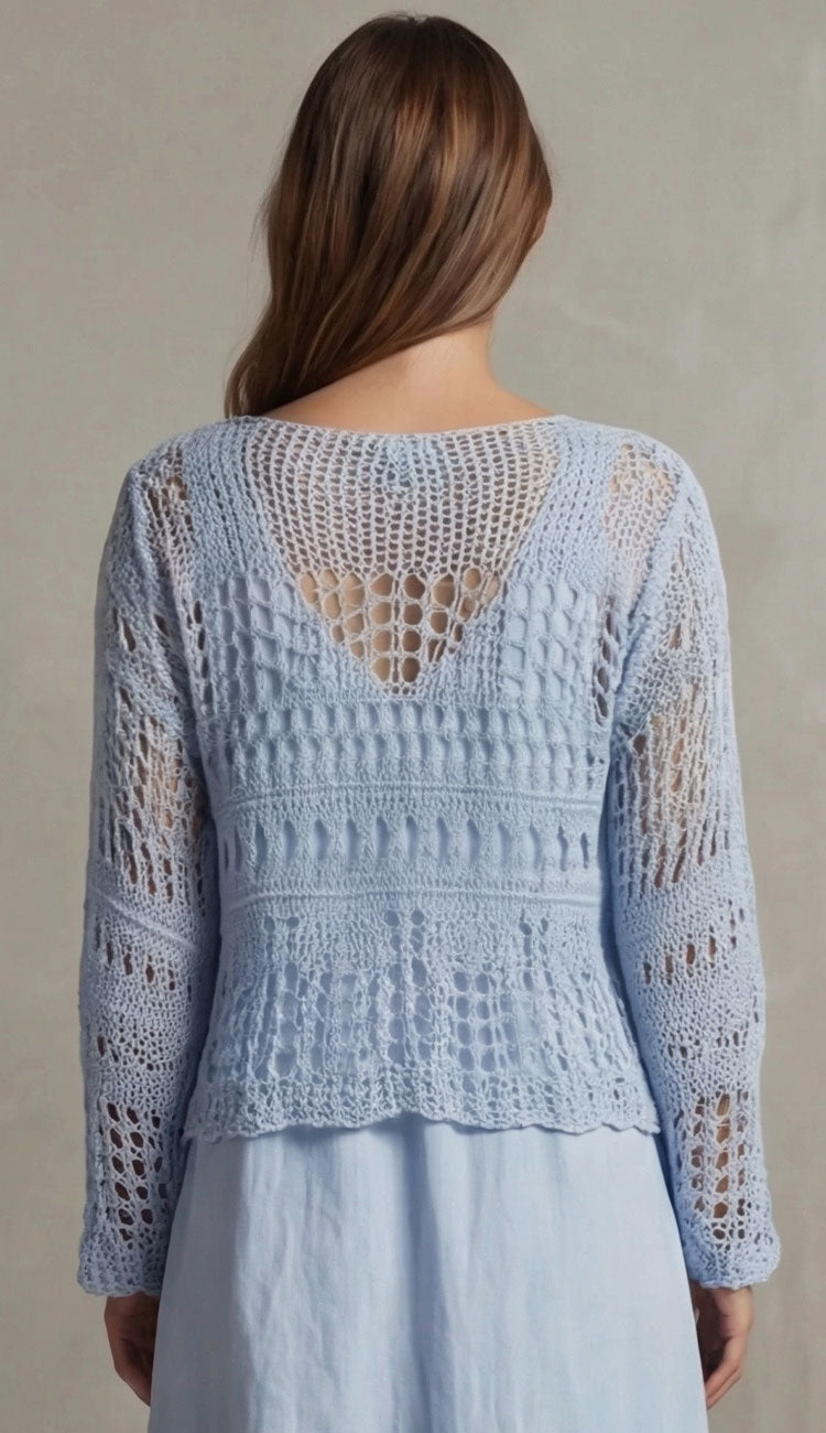 Woman wearing milio milano sky blue crochet top back view against a neutral background