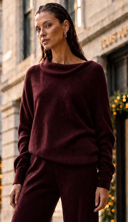 Milio Milano Wine asymmetrical top on model with matching flair pants