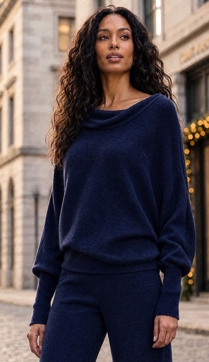 Milo Milano asymmetrical sweater worn like a mock-neck sweater and flair pants on model