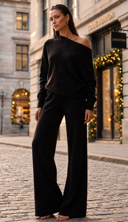 Milio Milano viscose flair pants paired with the asymmetrical top on a model in a city street 

