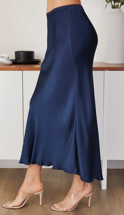 Navy blue skirt worn by a person in a minimal indoor setting