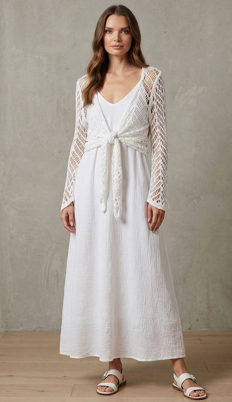 Women wearing a milio milano open knit crochet tie top in white over a linen dress
