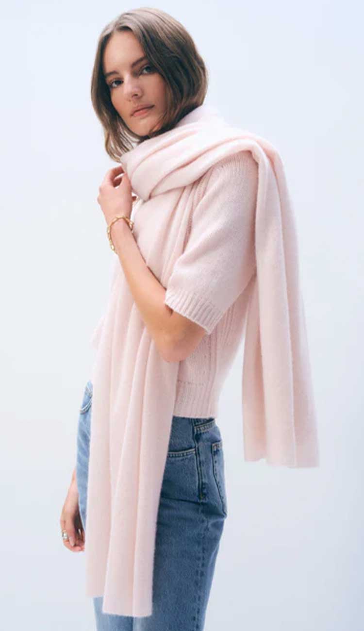 White + Warren cashmere travel wrap in Pink Sand, a lightweight rectangular 100% cashmere wrap styled as a scarf.