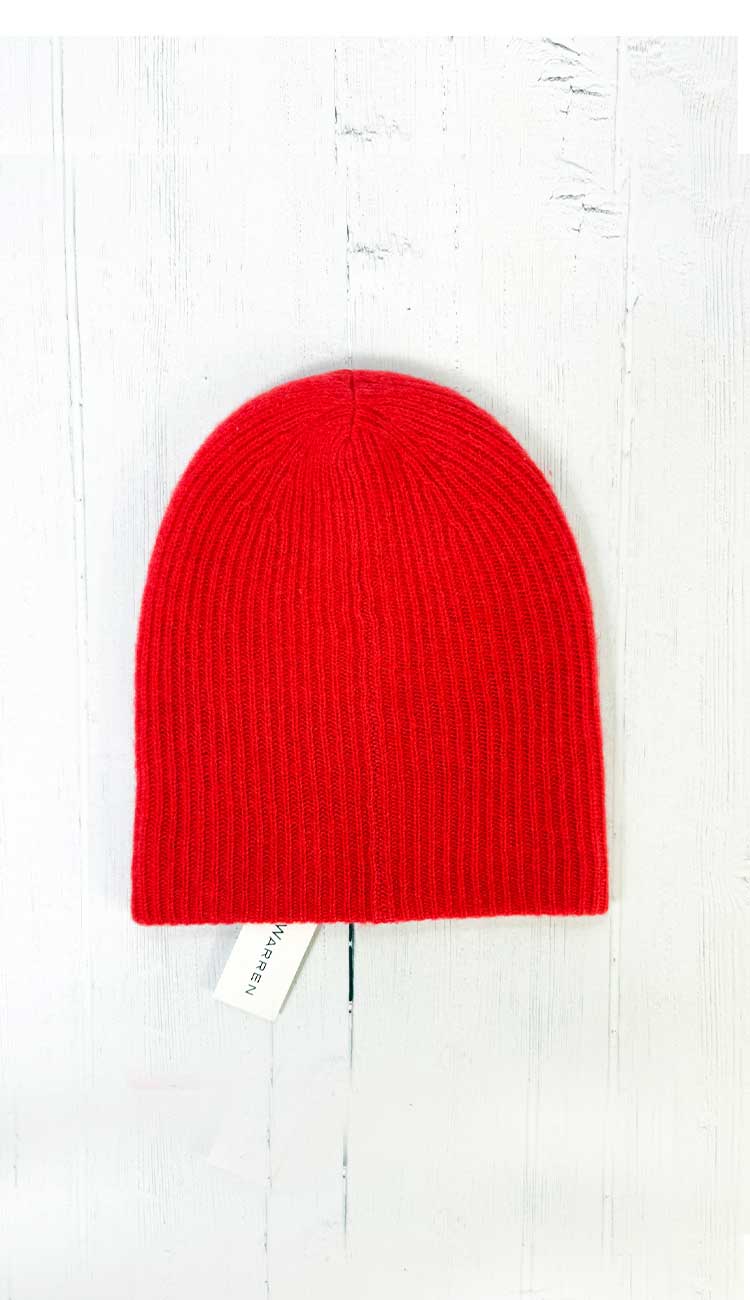 Red beanie on a white wooden surface
