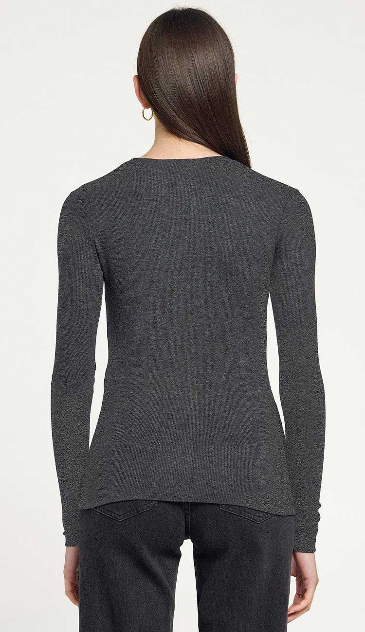 Ribbed long sleeve tee shirt in charcoal grey on a model with black pants on a white background - front view