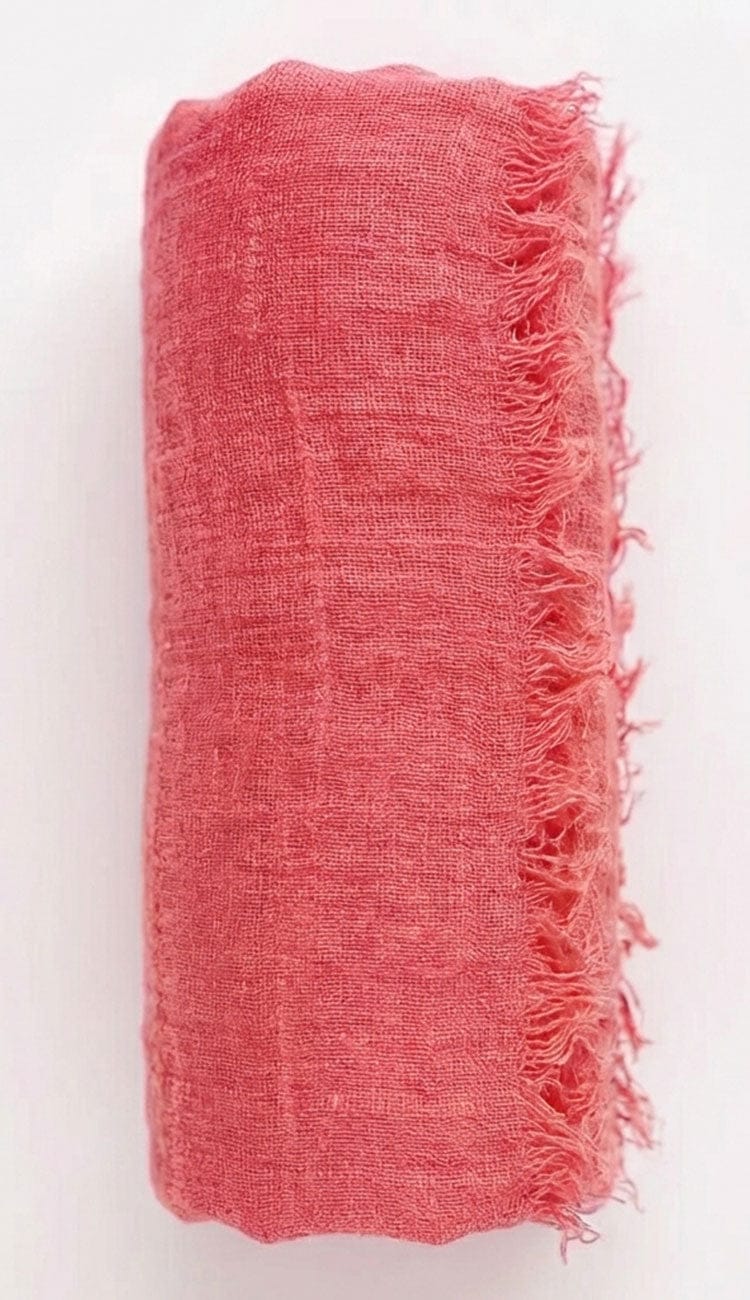 salmon fabric with frayed edges on a white background