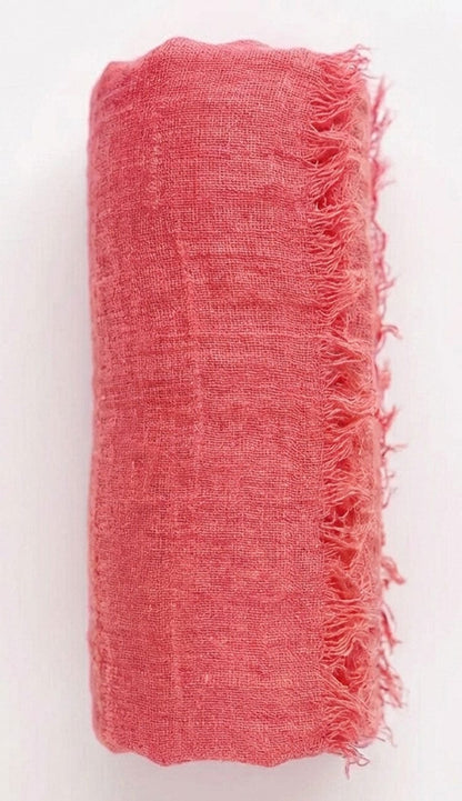 salmon fabric with frayed edges on a white background