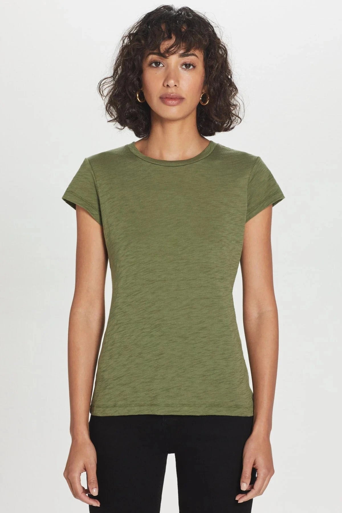 Woman wearing a green t-shirt against a white background