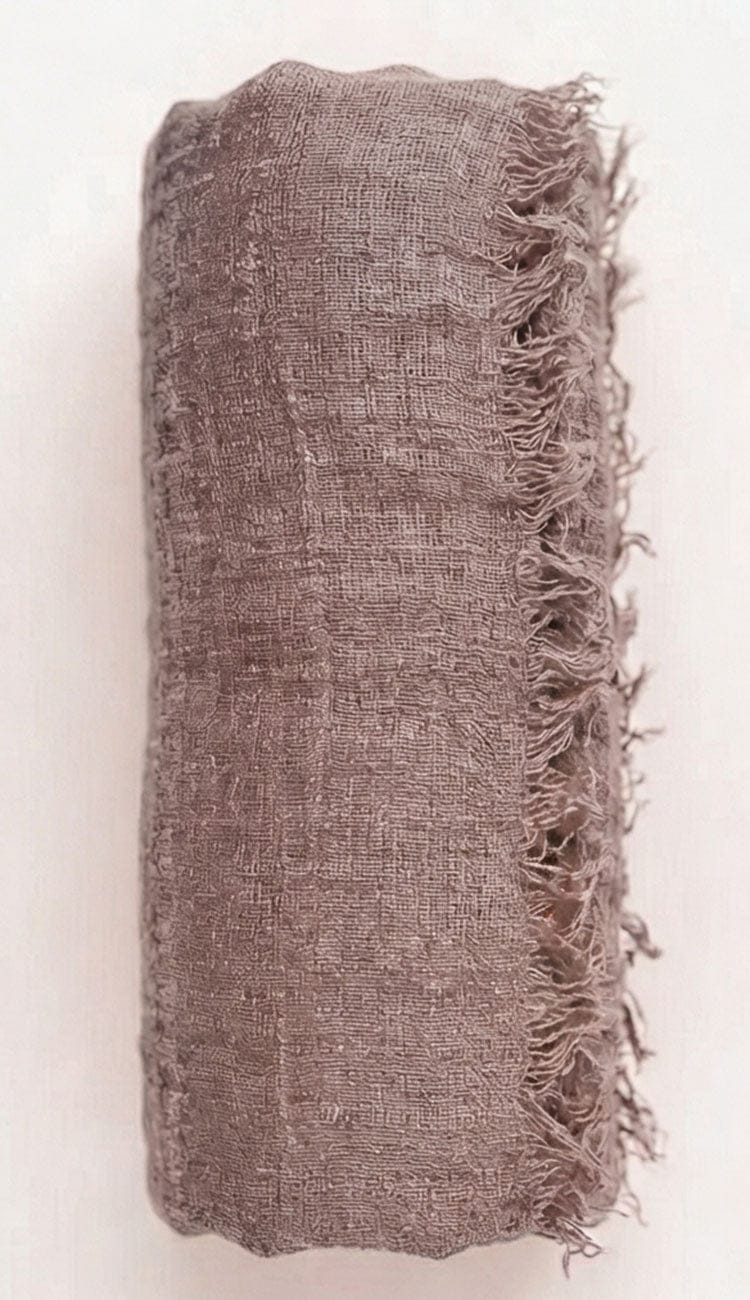 Taupe Textured fabric with frayed edges on a white background
