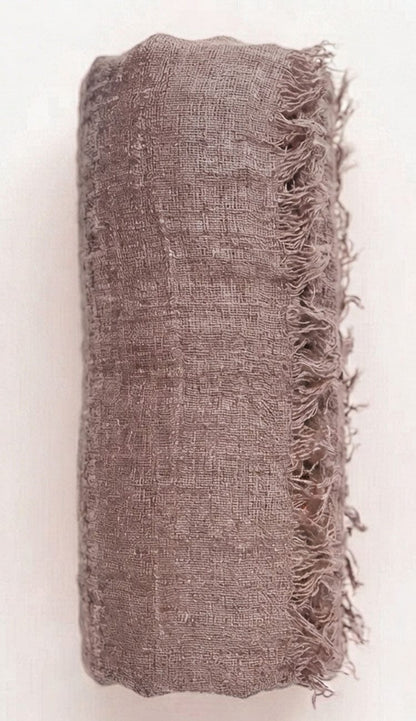 Taupe Textured fabric with frayed edges on a white background
