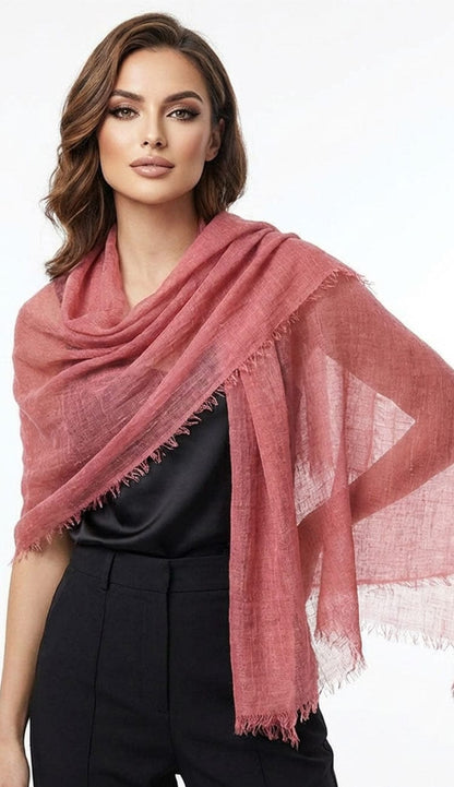 Woman wearing a terracotta scarf on a white background