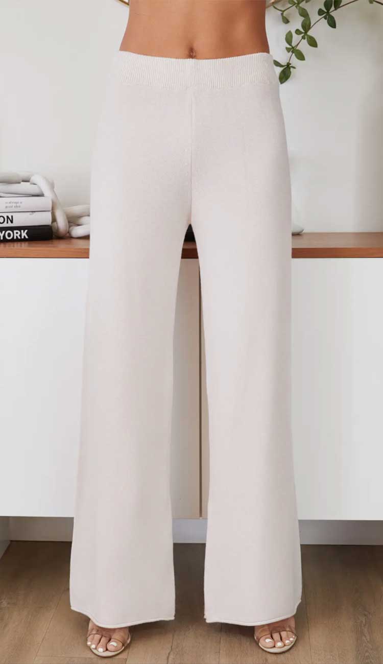 Beige wide-leg pants worn by a person on a white background