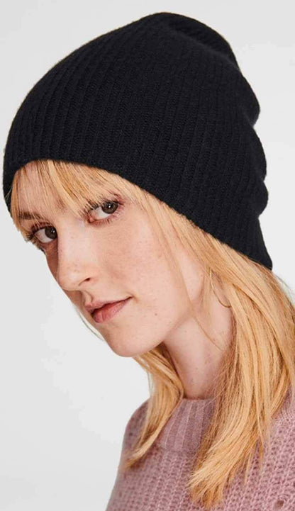 woman wearing a cashmere beanie in black by White and Warren on a white background