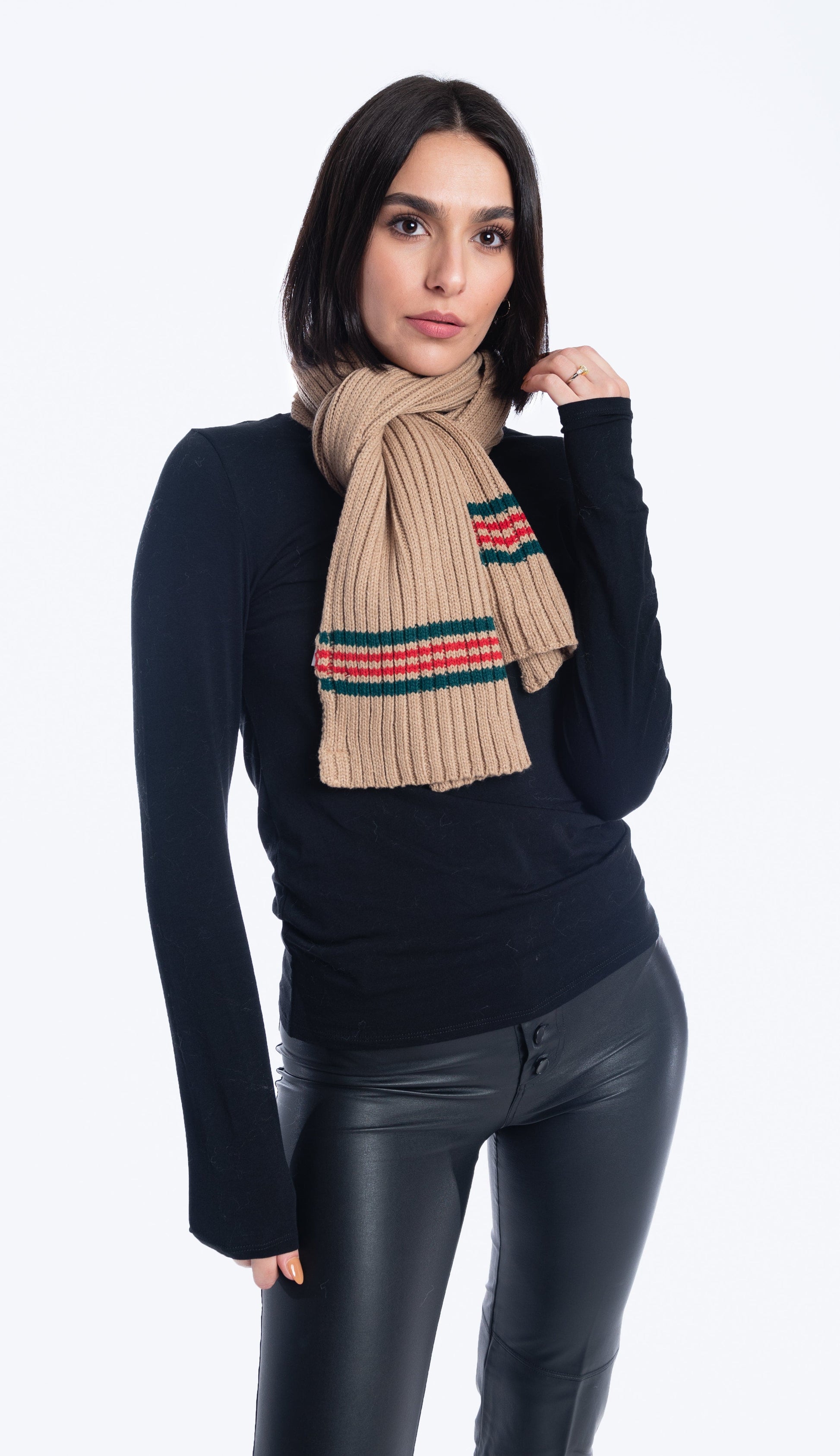 BEIGE SCARF WITH RED AND GREEN STRIPES OVER A BLACK SWEATER