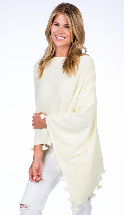 ALASHAN CASHMERE TOSSEL TOPPER IN lemon ice OVER BLUE JEANS