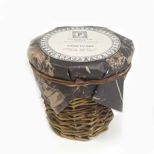 sanctuary candle in French wicker vessel by porch view home - paula and chlo