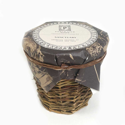sanctuary candle in French wicker vessel by porch view home - paula and chlo