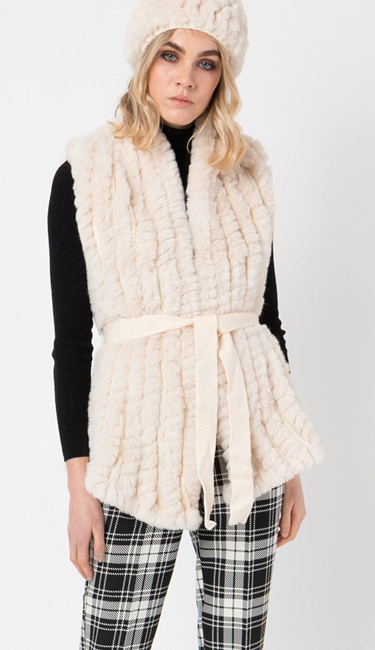 tazmin gallet vest in fur cream color with plad pants and black sweater 