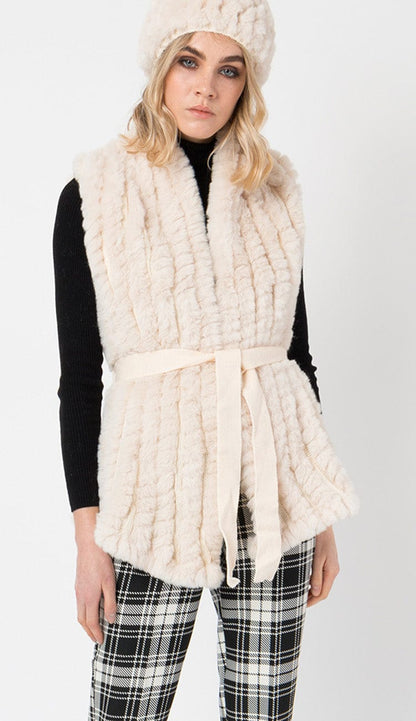 tazmin gallet vest in fur cream color with plad pants and black sweater 
