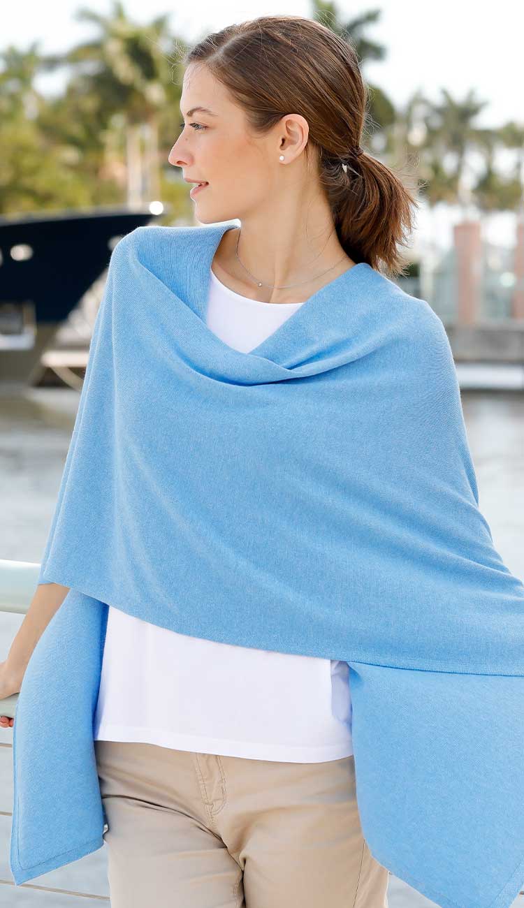 Woman wearing the Alashan Cotton Cashmere Trade Wind Dress Topper in Windswept, styled with blue jeans, featuring a relaxed draped silhouette and soft cotton cashmere knit.